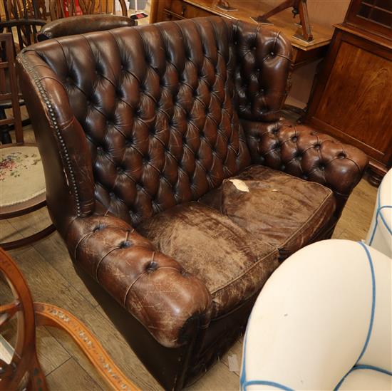 A leather button back high back two seater settee W.135cm